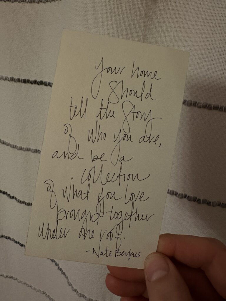 a note card with the quote, Your home should tell the story of who you are, and be a collection of what you love, brought together under one roof. From Nate Berkus